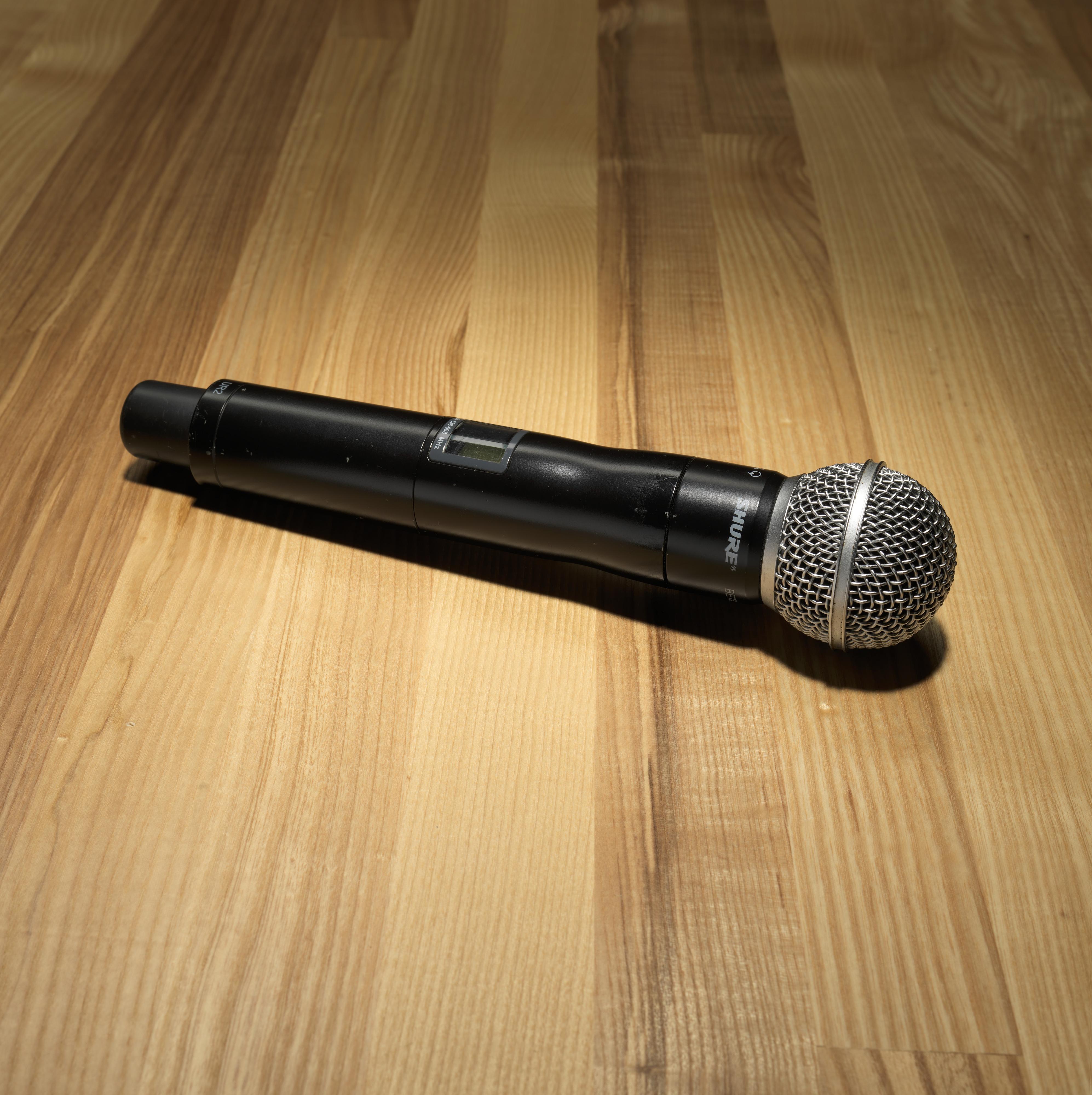 A microphone lying on a wooden floor