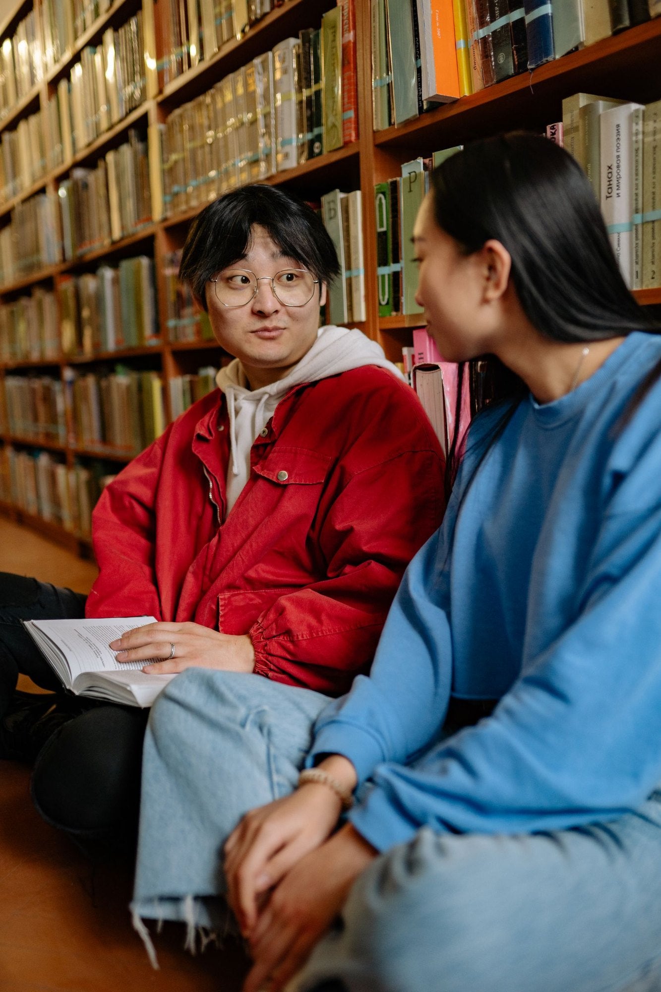 Two students studying together in a library