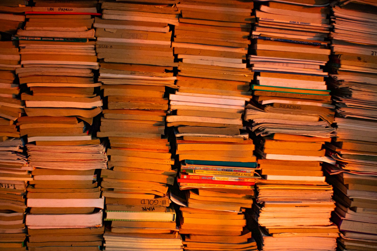 Stacks of old books, lit warm