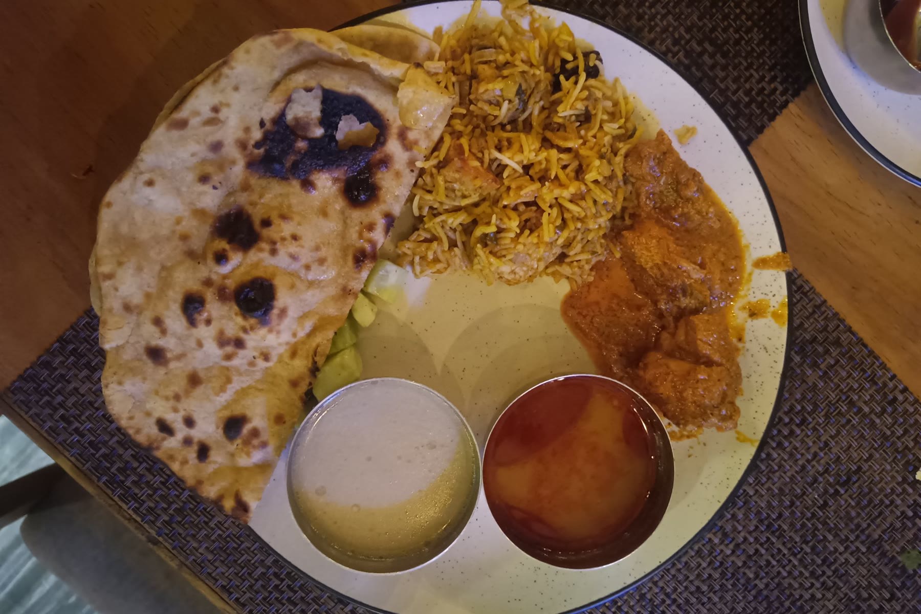 An Indian thali with naan, biryani and curry