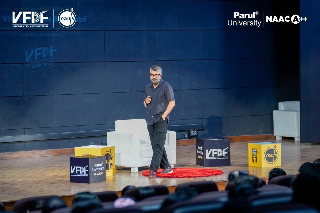 Vivek Agnihotri on stage at Parul University, the audience in the foreground